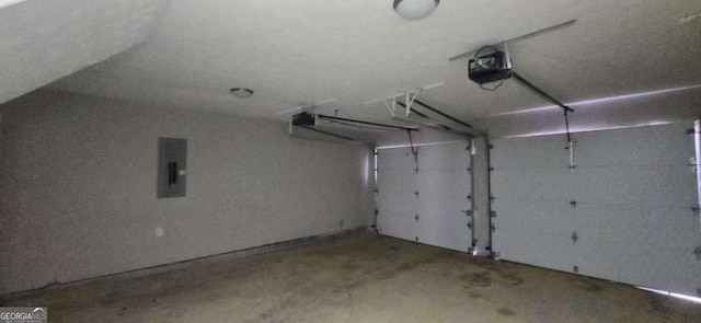 garage featuring electric panel and a garage door opener