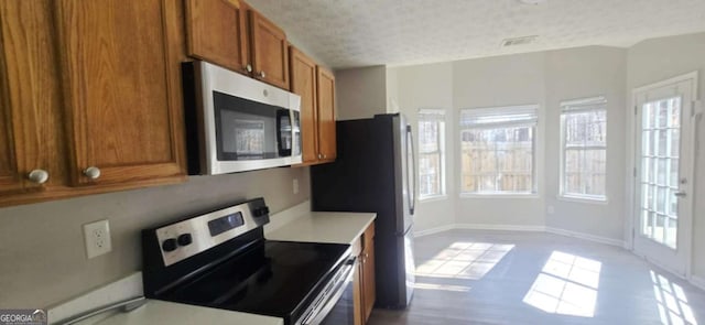 kitchen featuring a textured ceiling and stainless steel appliances