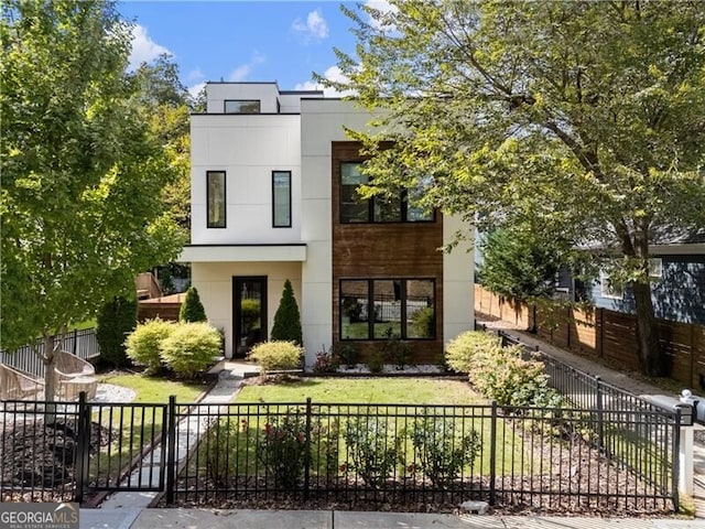 contemporary home with a front lawn