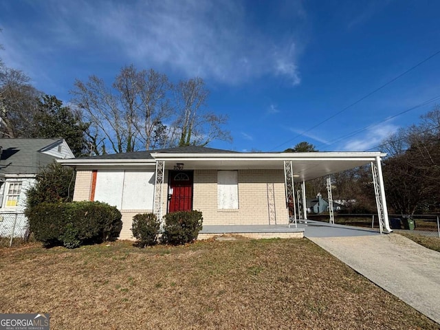 view of front of house with a front lawn and a carport