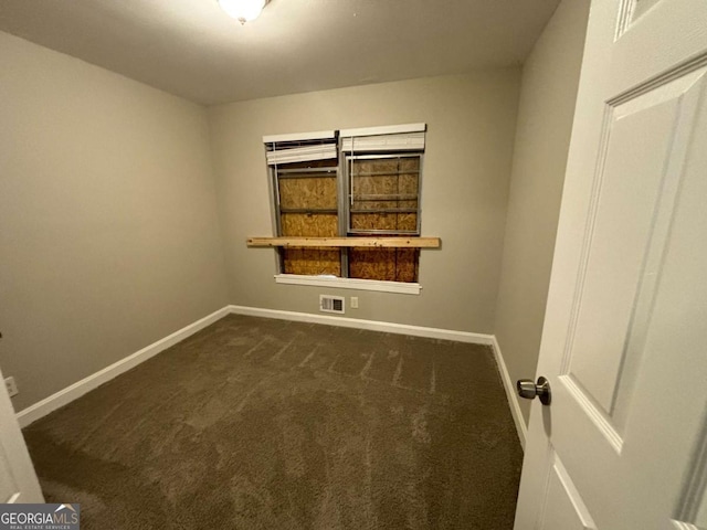 empty room with dark carpet