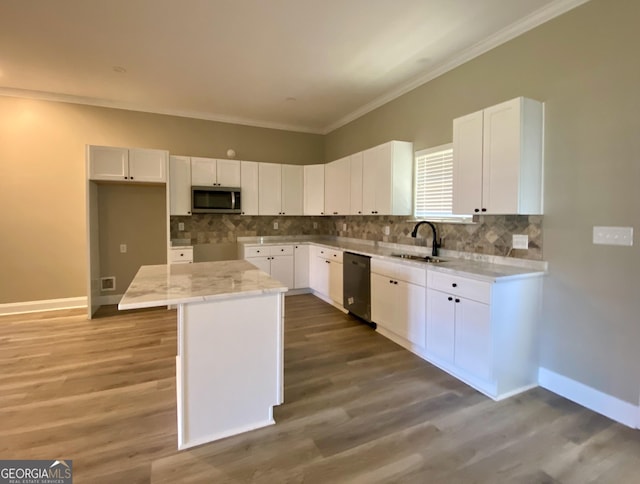 kitchen with white cabinets, sink, stainless steel appliances, and a kitchen island