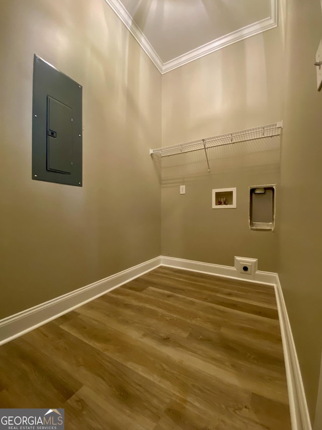 clothes washing area featuring wood-type flooring, hookup for a washing machine, hookup for an electric dryer, electric panel, and crown molding