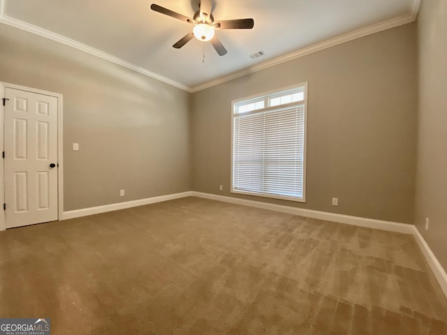 carpeted empty room featuring ceiling fan and ornamental molding