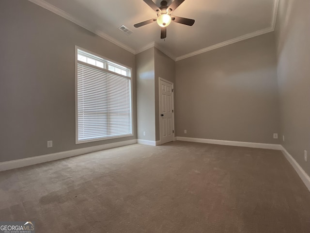 carpeted spare room featuring ceiling fan and crown molding