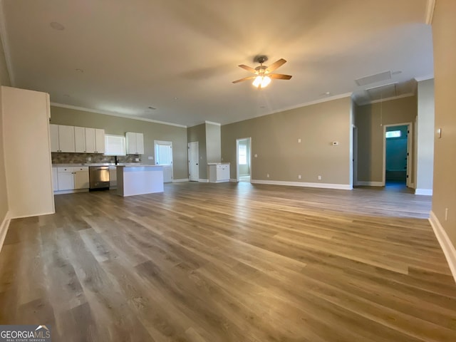 unfurnished living room with ceiling fan, ornamental molding, and light hardwood / wood-style floors