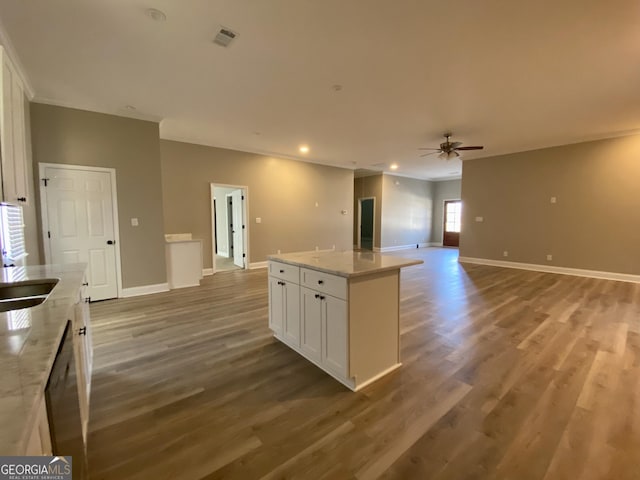 kitchen featuring ceiling fan, hardwood / wood-style floors, white cabinets, and a kitchen island