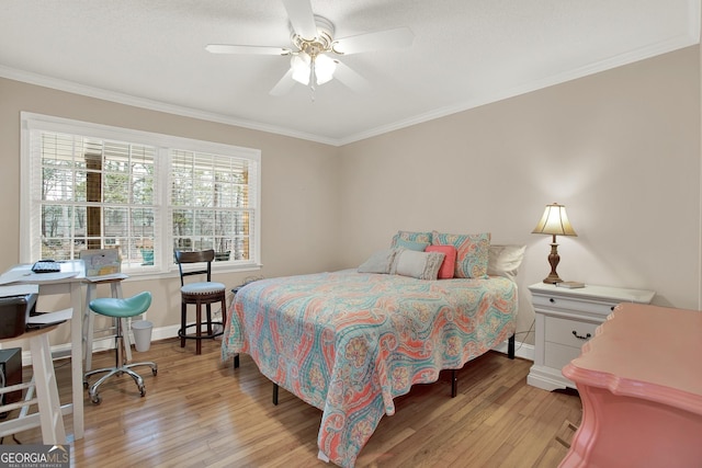 bedroom with ceiling fan, ornamental molding, and light wood-type flooring