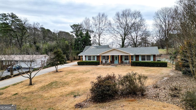 single story home with a front lawn and a porch