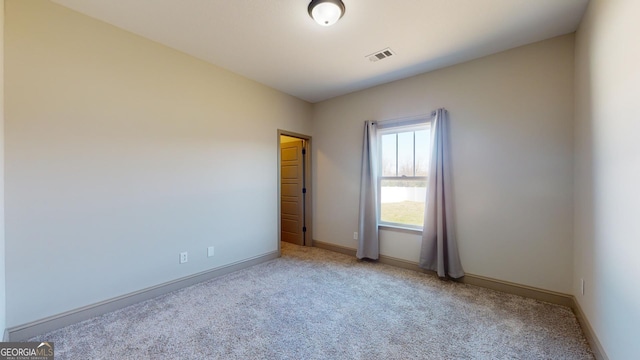 empty room featuring light colored carpet