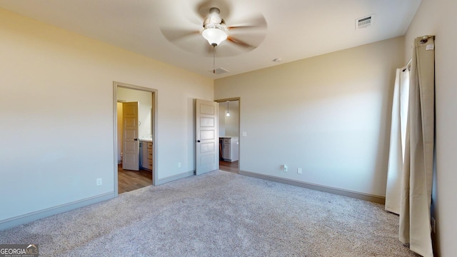 unfurnished bedroom featuring ceiling fan, light carpet, and connected bathroom