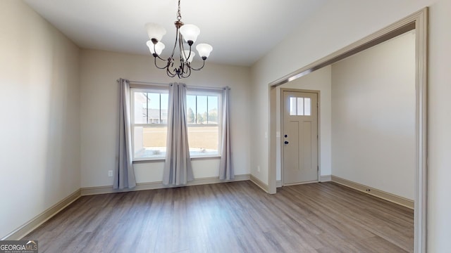 interior space featuring an inviting chandelier and light hardwood / wood-style flooring