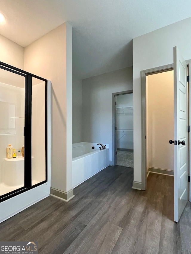 bathroom featuring independent shower and bath and hardwood / wood-style flooring