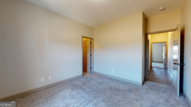 unfurnished bedroom with light colored carpet