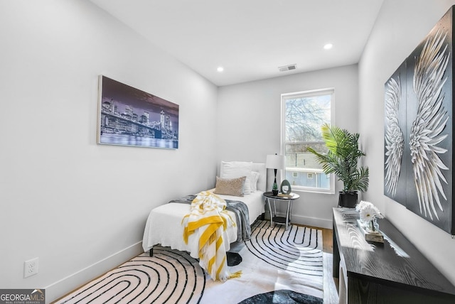 bedroom featuring recessed lighting, wood finished floors, visible vents, and baseboards