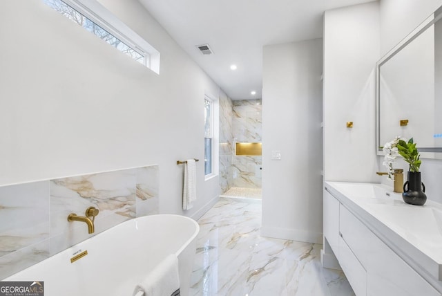 full bathroom featuring marble finish floor, a marble finish shower, visible vents, a freestanding bath, and vanity