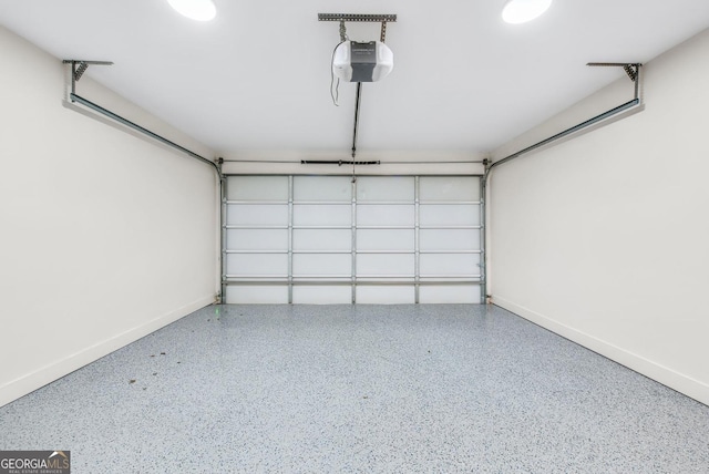 garage with a garage door opener and baseboards