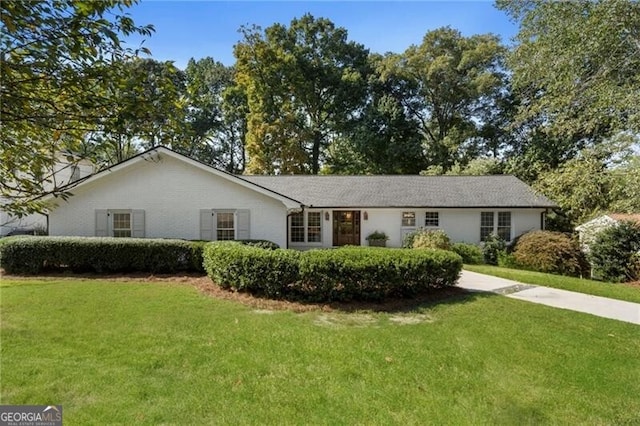 ranch-style home with a front lawn