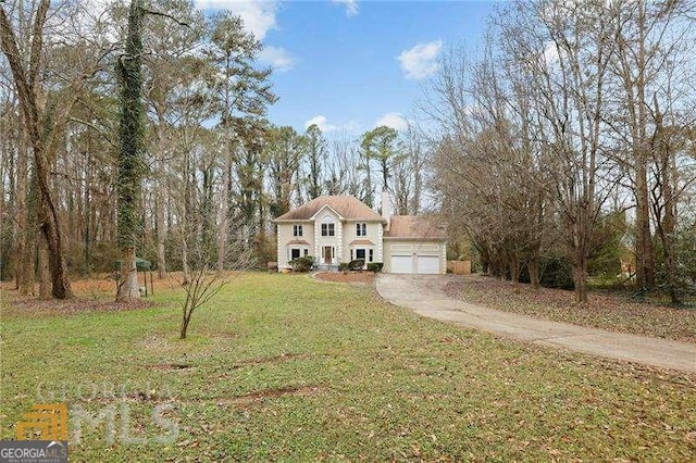 view of front of property with a garage and a front yard