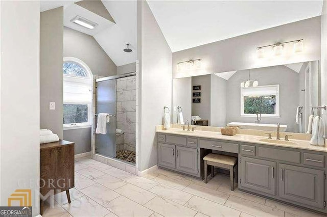 bathroom with lofted ceiling, vanity, a shower with door, and a wealth of natural light