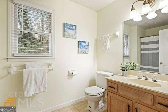 bathroom featuring toilet and vanity