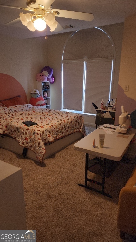 carpeted bedroom with ceiling fan