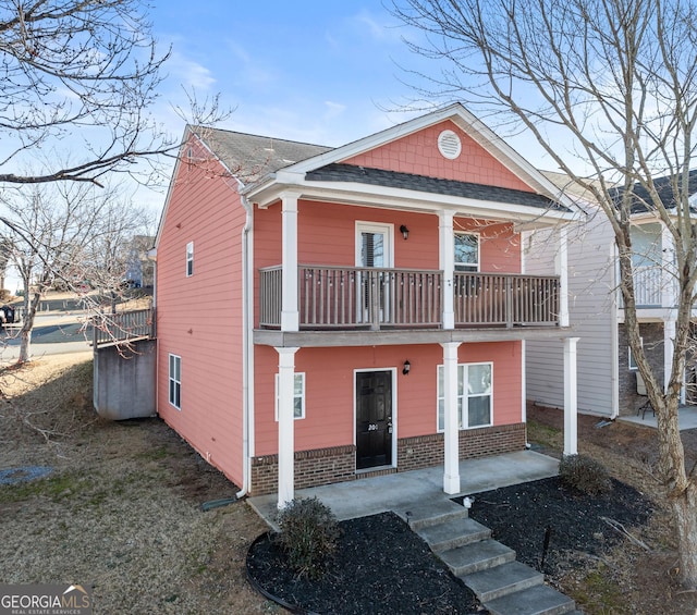 view of front of home featuring a porch and a balcony