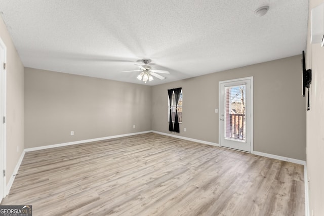 unfurnished room with light hardwood / wood-style floors, a textured ceiling, and ceiling fan