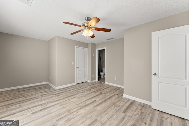 unfurnished room with a textured ceiling, ceiling fan, and light hardwood / wood-style floors