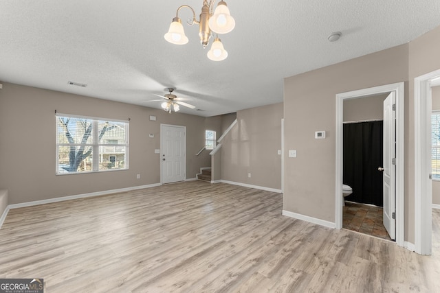 unfurnished living room featuring a textured ceiling, ceiling fan, and light hardwood / wood-style flooring