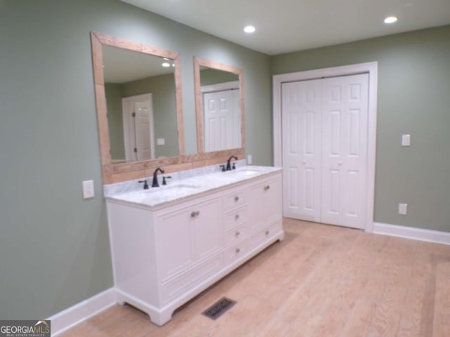 bathroom with wood-type flooring and vanity