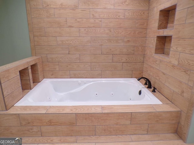 bathroom featuring tiled tub