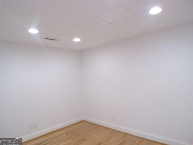 unfurnished room with hardwood / wood-style flooring