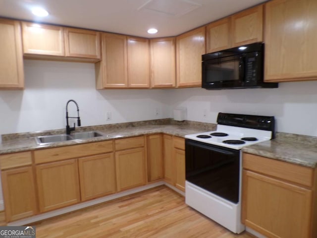 kitchen with electric stove, light brown cabinets, light hardwood / wood-style flooring, and sink