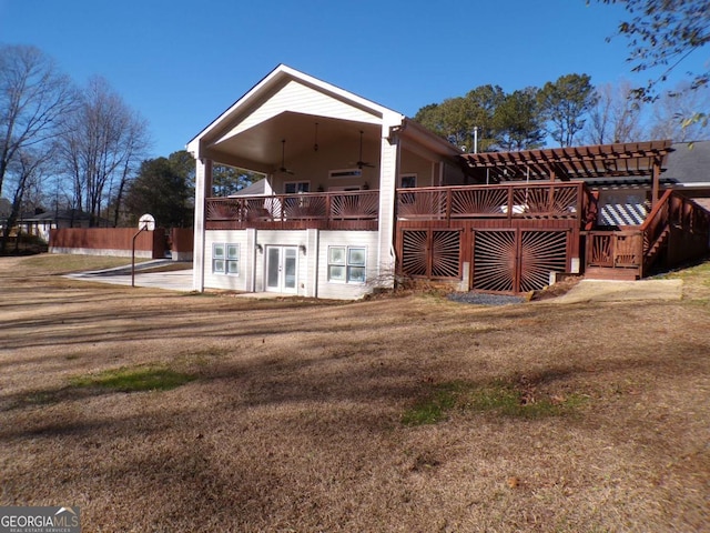 back of property with ceiling fan, french doors, and a lawn