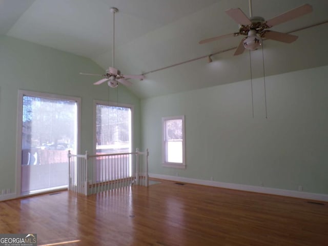 spare room featuring ceiling fan, wood-type flooring, and vaulted ceiling