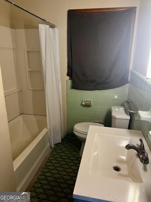 full bathroom with toilet, shower / tub combo, tile walls, and sink