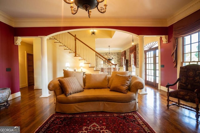 living room with wood-type flooring, ornamental molding, and ornate columns