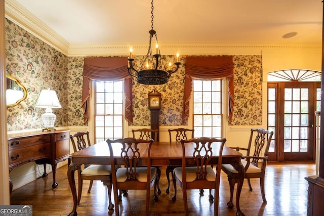 dining space featuring ornamental molding, a chandelier, and hardwood / wood-style floors