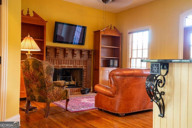 living area with a fireplace and hardwood / wood-style floors