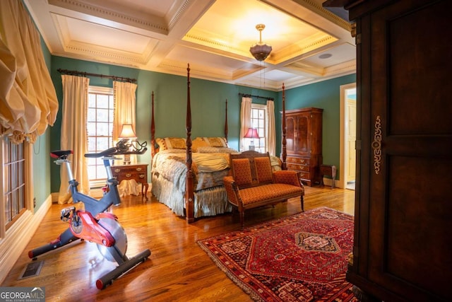 bedroom with crown molding, wood-type flooring, beam ceiling, and coffered ceiling