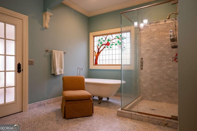 bathroom featuring crown molding and separate shower and tub