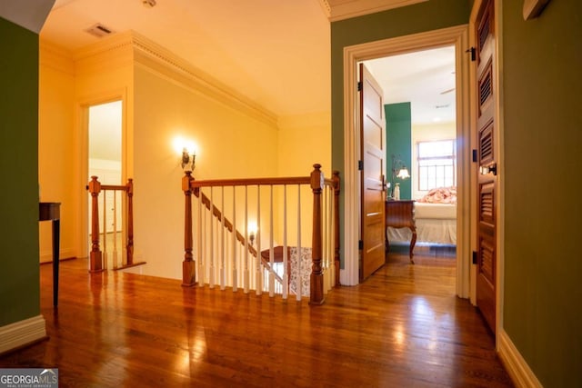 corridor featuring crown molding and hardwood / wood-style flooring