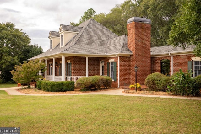 new england style home with covered porch and a front lawn