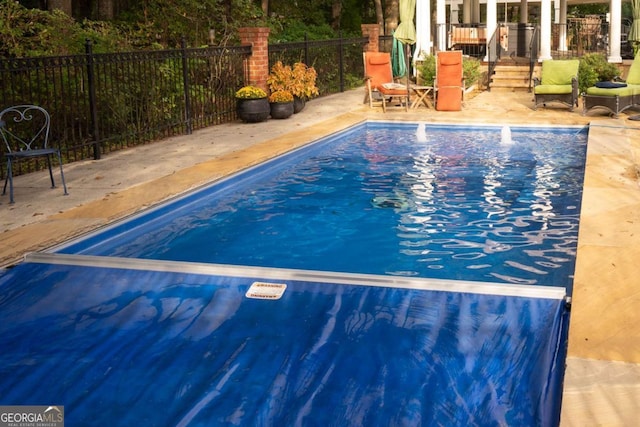 view of pool featuring a patio area