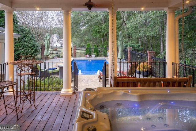 wooden terrace with a swimming pool with hot tub