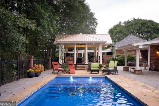 view of swimming pool featuring a gazebo, outdoor lounge area, and a patio