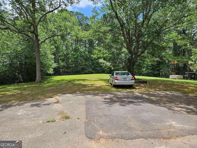 view of car parking featuring a lawn