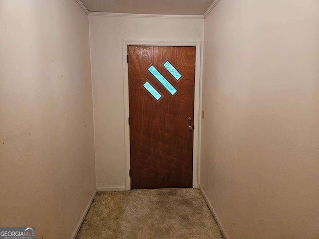 doorway featuring light colored carpet and ornamental molding