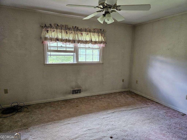 carpeted spare room featuring ceiling fan